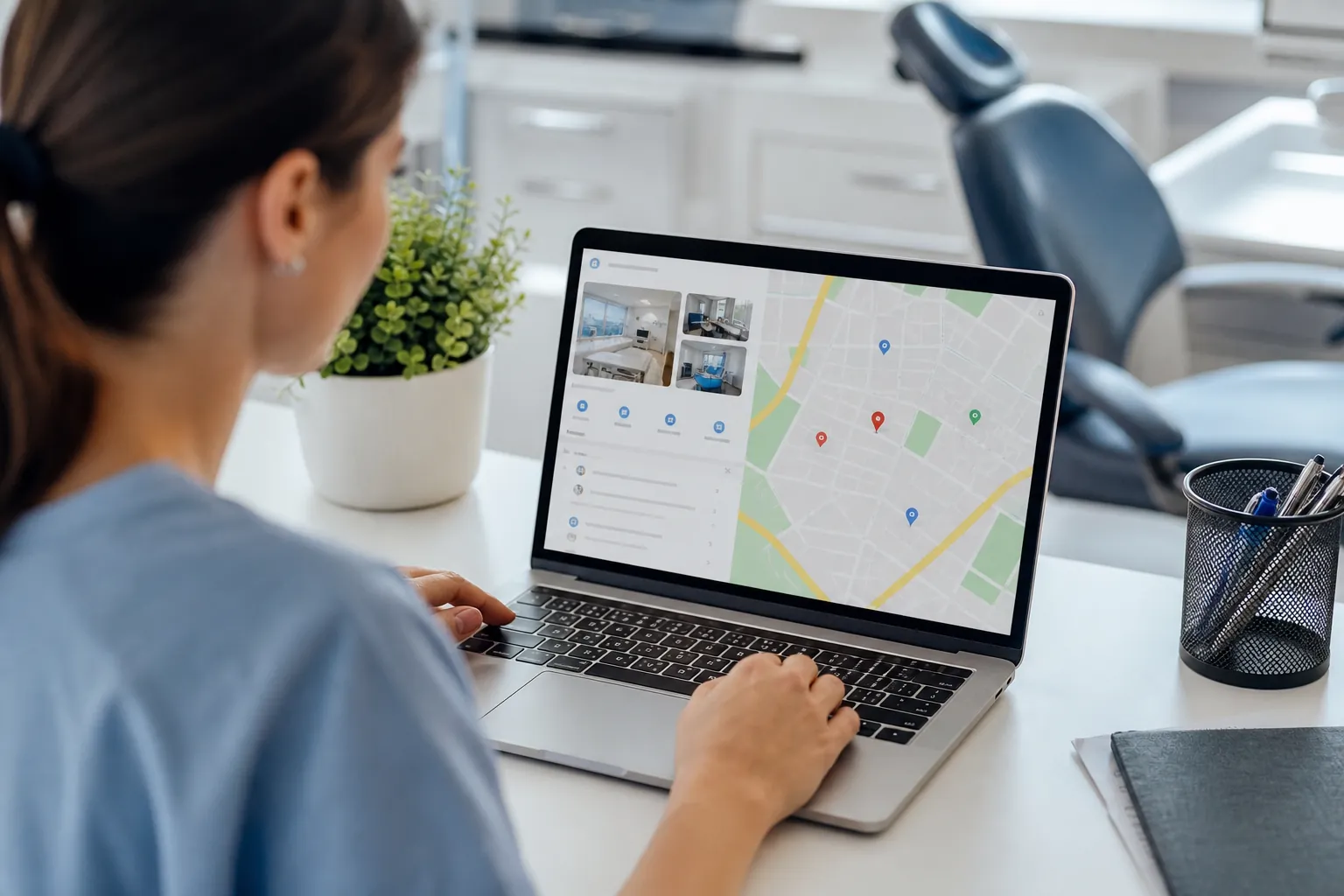 Dental professional reviews a local business map and practice photos on a laptop beside a dental chair.